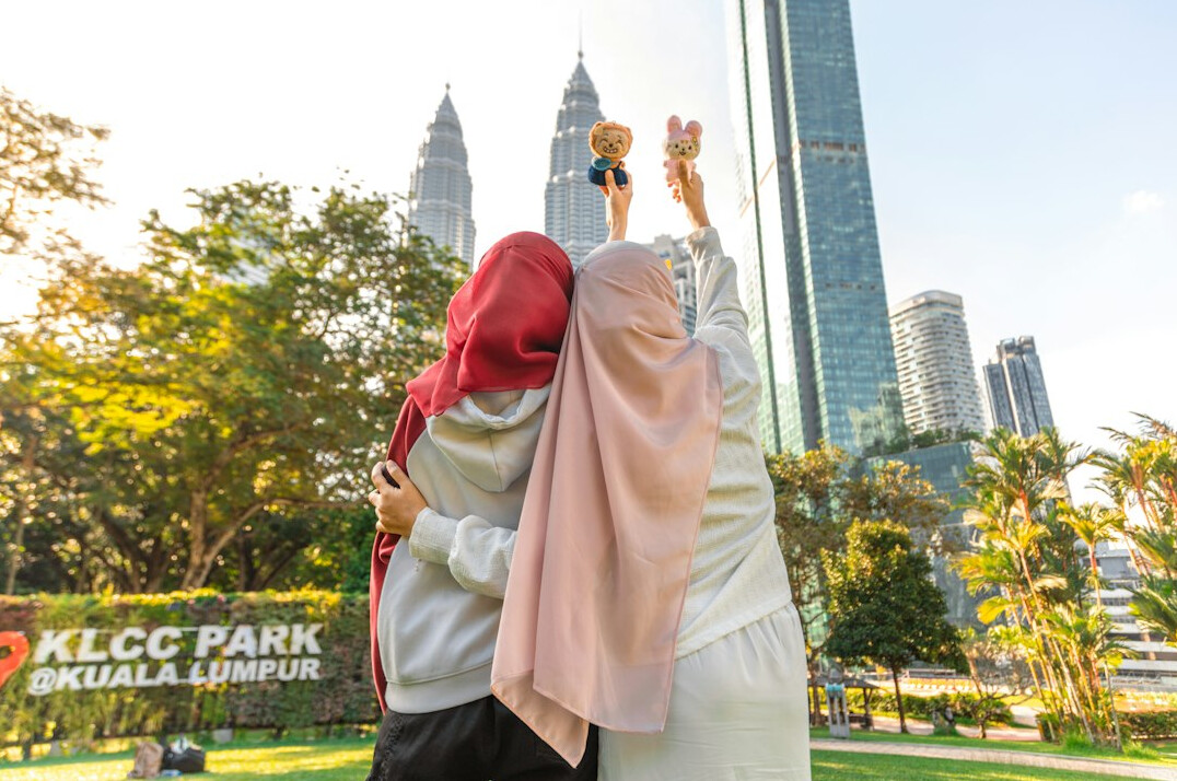 Group of young Malaysian professionals celebrating outdoors